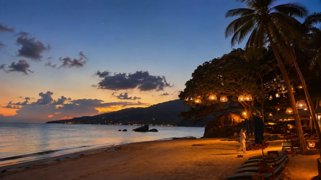 Luxury beachfront resort glowing at sunset with palm trees along the beach in Koh Samui